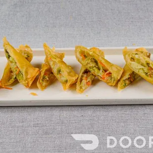 a platter of wontons with dipping sauce