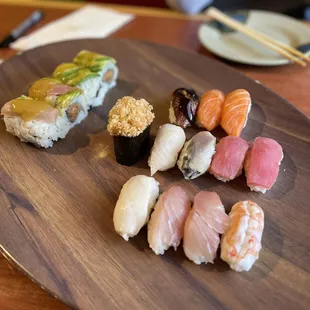 a variety of sushi on a wooden plate