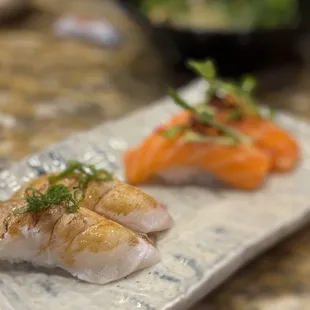 two pieces of sushi on a plate