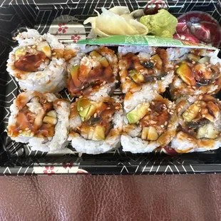 a plate of sushi with a side of avocado