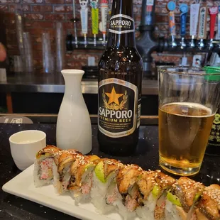 Dragon roll and sake + Sapporo