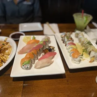 three plates of sushi and fries