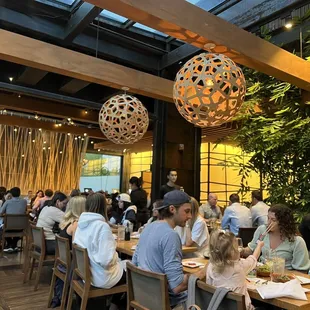 a large group of people eating at a restaurant