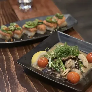 two plates of food on a wooden table