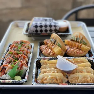 a tray of sushi and rolls