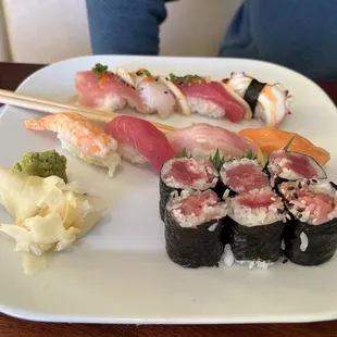 a plate of sushi with chopsticks