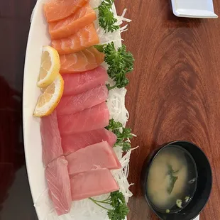 a large platter of sashi and lemon slices