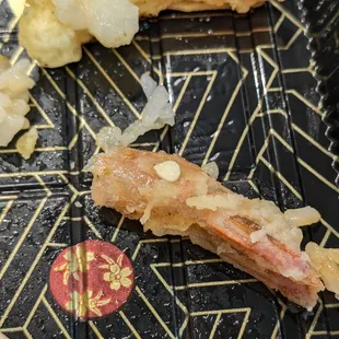 Pepper seed stuck to one of the shrimp tails from the end of my sushi roll. This was after it was "remade."