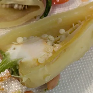The pepper included in every dish, peeled, cooked, and cut to expose seeds.