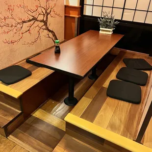 a table and benches in a japanese restaurant