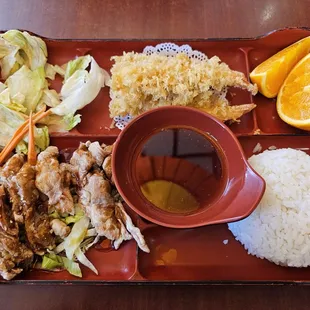Bento box with sesame chicken and shrimp tempura.