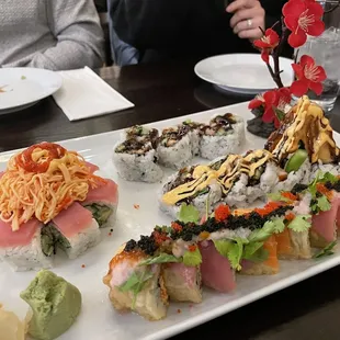 a variety of sushi on a white plate