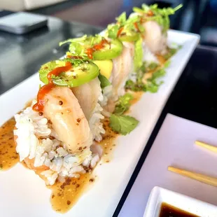 a plate of sushi and chopsticks