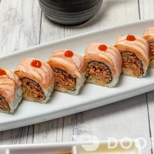 a plate of sushi and chopsticks