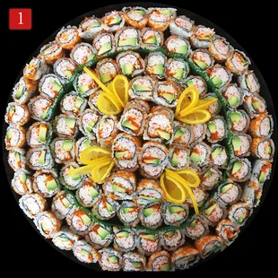 a plate of sushi with lemon slices