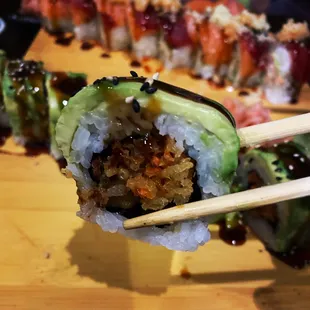 Vegetarian Roll (flash fried carrots and onions topped with avocado, unagi sauce and sesame seeds)
