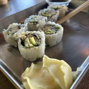 Custom sushi with avocado, chicken, cucumber, and green chili. The eel sauce is also pictured in the top right corner.