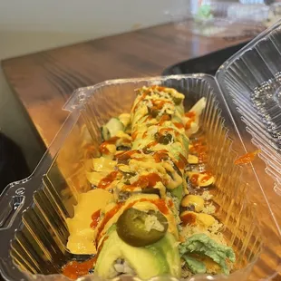 a sushi roll in a plastic container