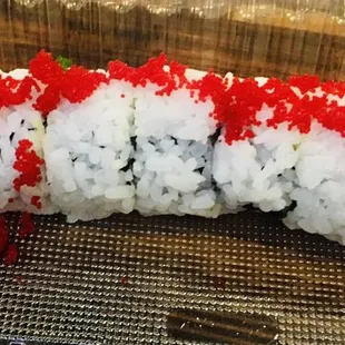 a sushi roll with red and white sprinkles