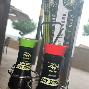 a pair of sushi sauces on a table