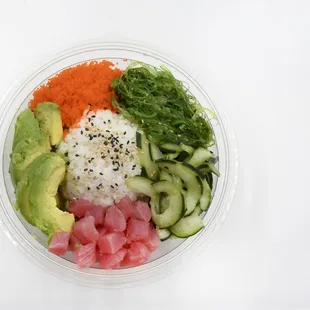 a plastic bowl filled with vegetables and rice