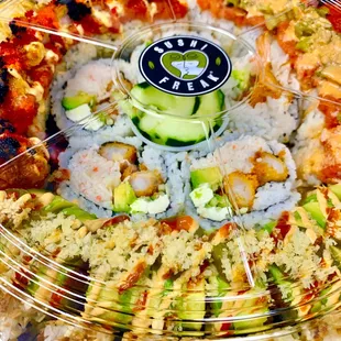 a platter of sushi rolls and vegetables