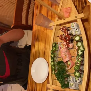 a woman preparing sushi on a boat