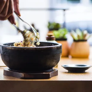 a person eating a bowl of food