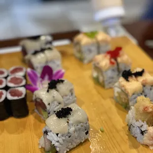 a variety of sushi on a wooden board