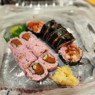 a variety of sushi in a plastic container