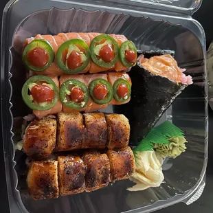 Spicy salmon hand roll and two other rolls