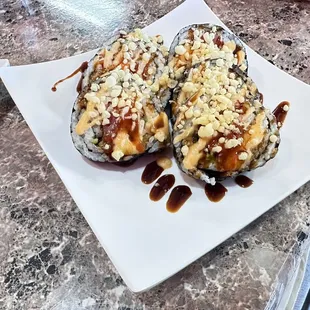 two pieces of sushi on a plate