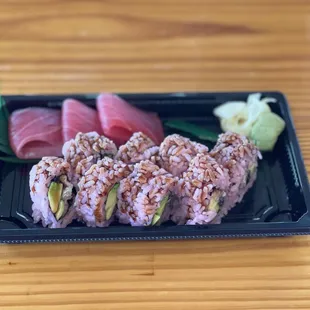 a plate of sushi on a wooden table