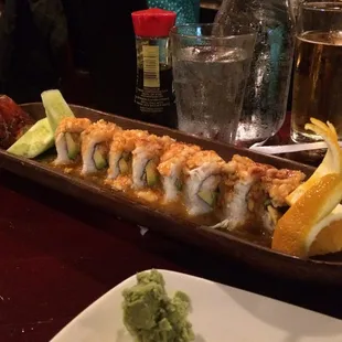 a plate of sushi and a glass of beer