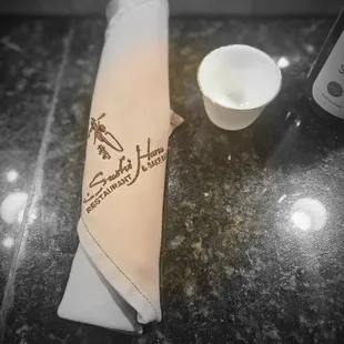 a napkin with a sushi logo on it