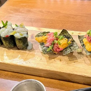 a variety of sushi on a wooden board