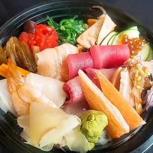 a bowl of sushi and vegetables