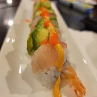 a sushi roll on a white plate