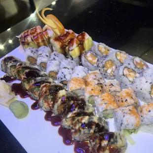 a plate of sushi and rolls