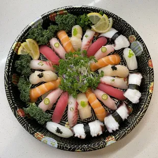 a plate of sushi and vegetables