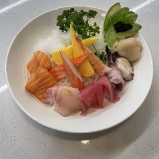a plate of sushi and vegetables