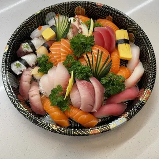 a bowl of sushi on a table