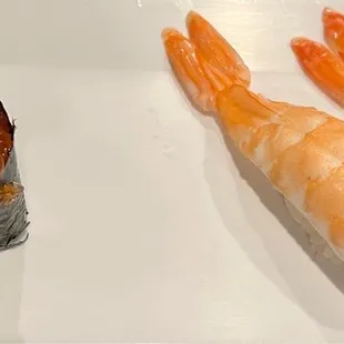 three pieces of sushi on a white plate