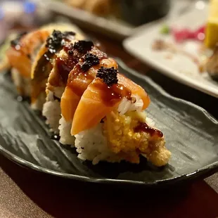 a plate of sushi and a plate of salad