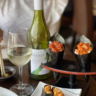 Uni, spicy tuna hand roll &amp; spicy salmon hand roll. Oh and a bottle of Sauvignon Blanc