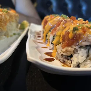 two plates of sushi on a table