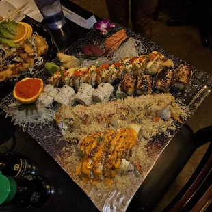 They served all the rolls and sashimi on a single plate.