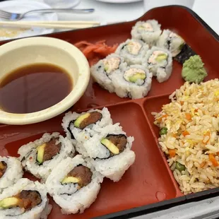 a plate of sushi and a bowl of sauce