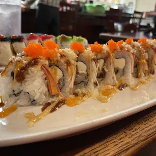 a plate of sushi with sauce on it