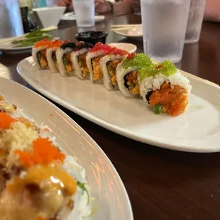 two plates of sushi and a glass of water